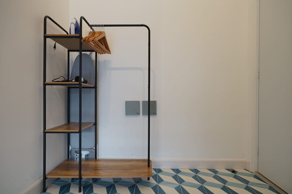 Open and minimalist closet with a coat rack