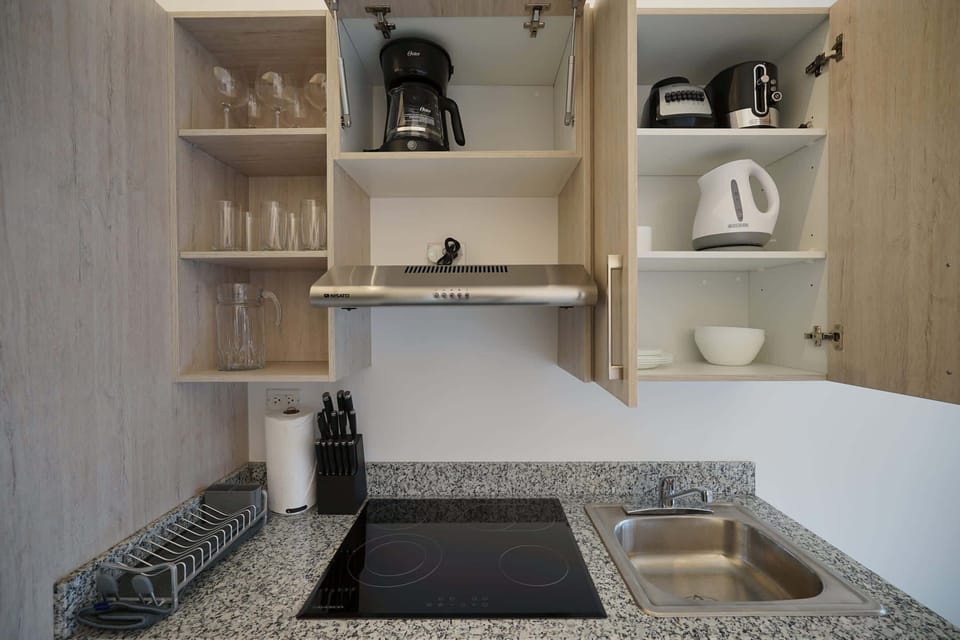 Full kitchen with coffee maker, microwave and utensils