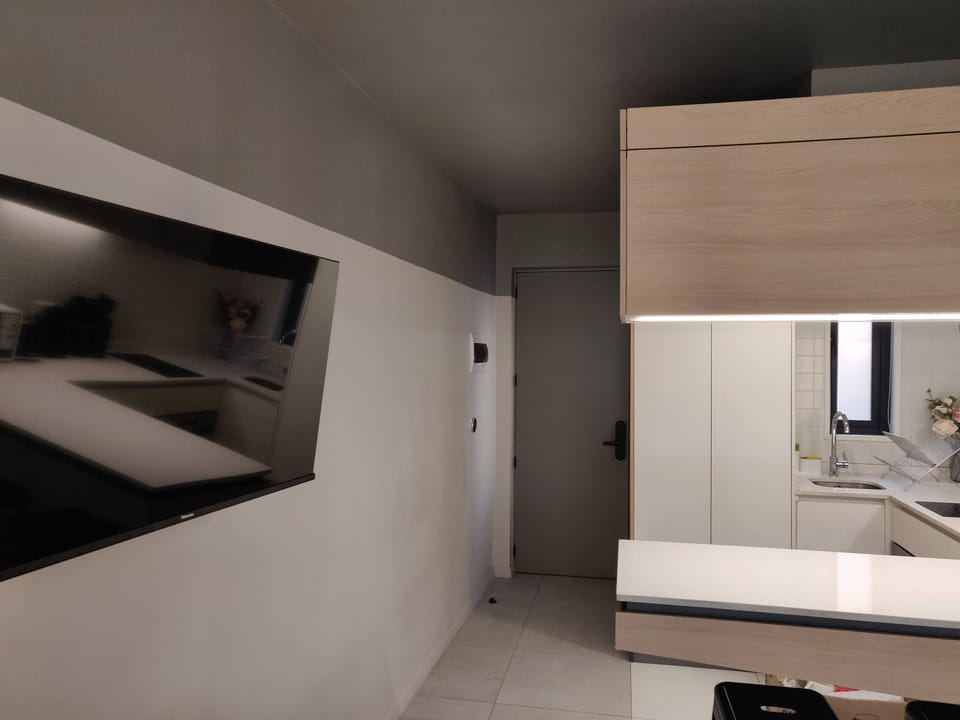 Modern kitchen with sleek design and convenient amenities, perfect for a cozy stay.