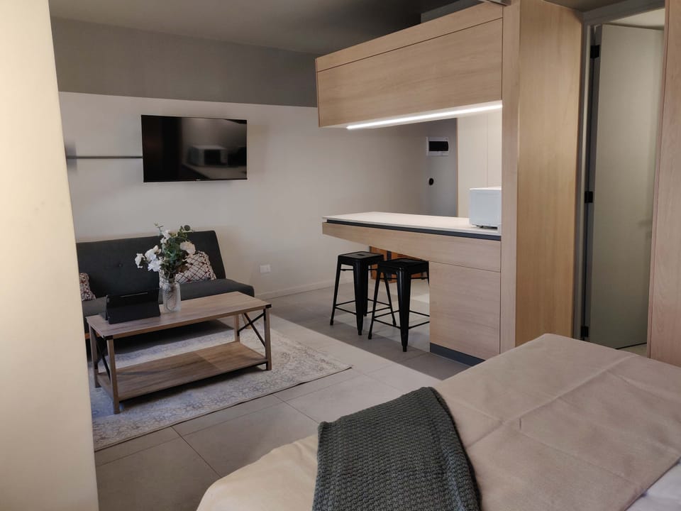 Cozy studio living area with modern amenities and a stylish dining nook, perfect for a relaxing stay.