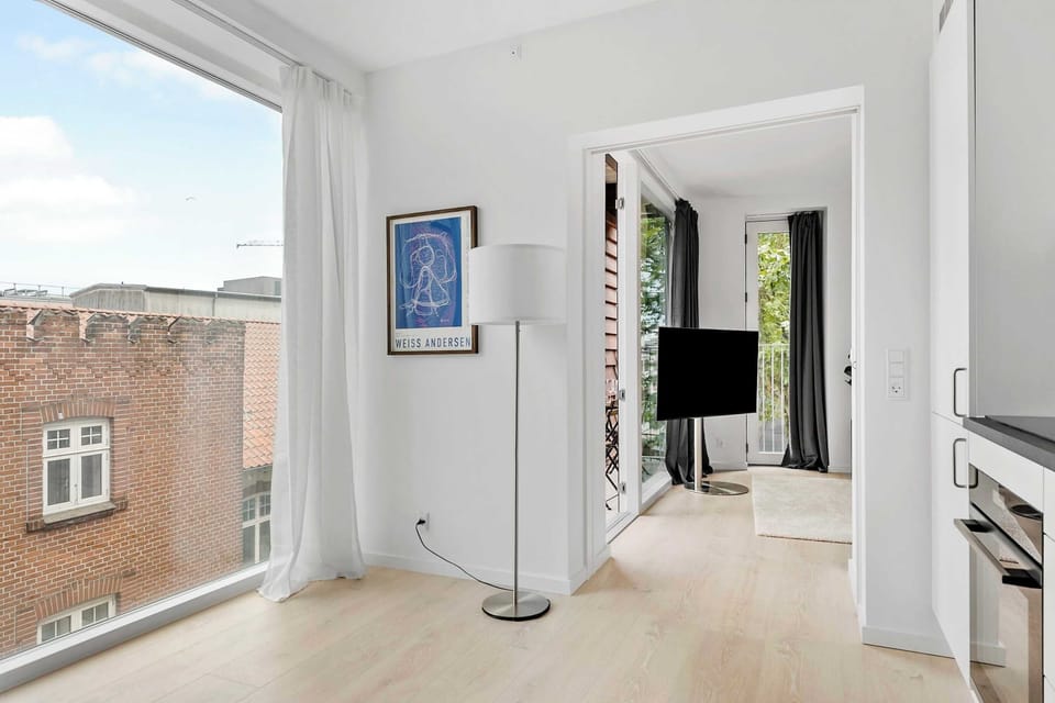 Bedroom entrance with huge floor to ceiling window in kitchen area