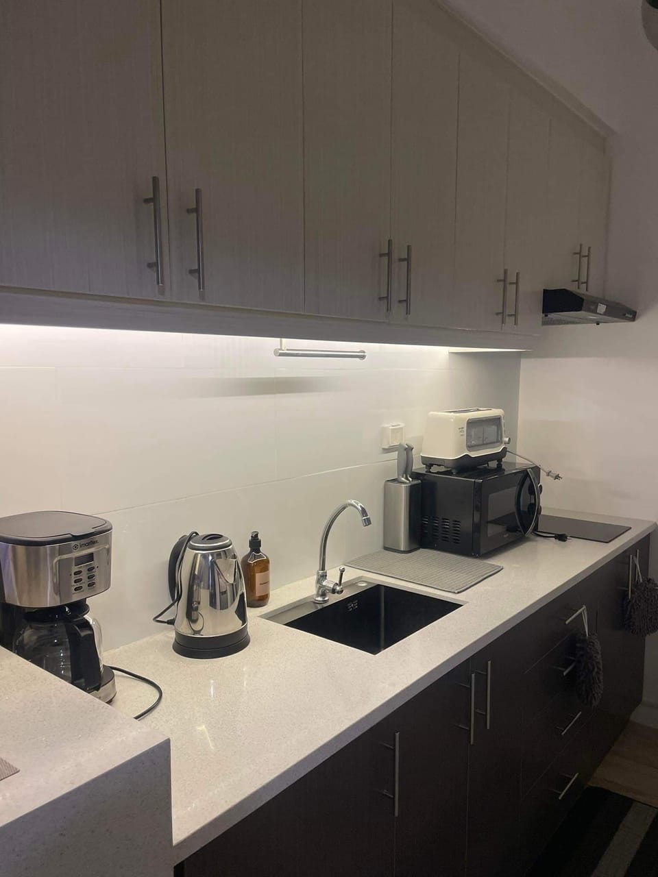 fully-equipped kitchen with LED strip lights under top kitchen cabinets