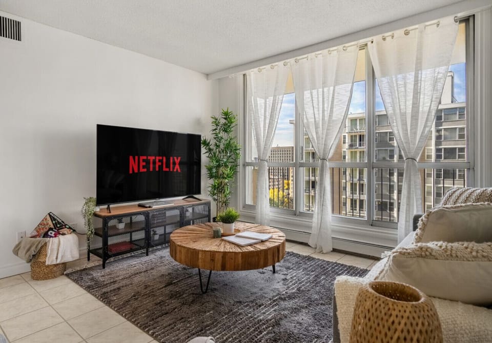 Cozy, luxurious & modern living room with real wood decor, 65` Smart TV with Netflix and Cable TV to enjoy your sports, news and more!