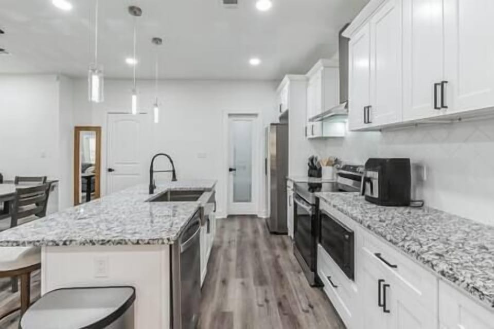 Kitchen area with pantry near the refrigerator/ freezer