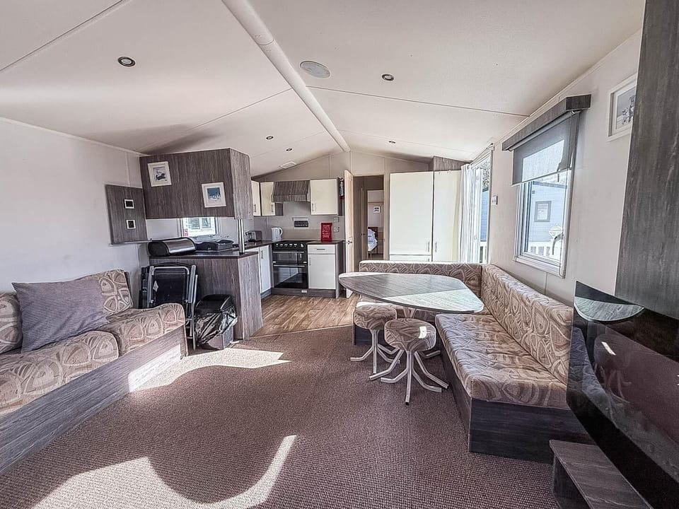 Whether it’s a rainy day or a cozy evening, the living room in a caravan offers the perfect space to relax during your dog friendly break UK on the Suffolk coast.
