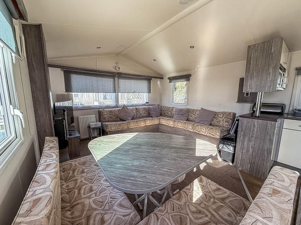The living room in a caravan at Broadland Sands Holiday Park Lowestoft is the perfect place to relax with your family after a day exploring the Suffolk coast and its many attractions.