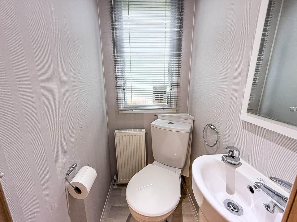 Our caravan at California Cliffs Holiday Park features a well-designed bathroom that offers a practical space for everyone