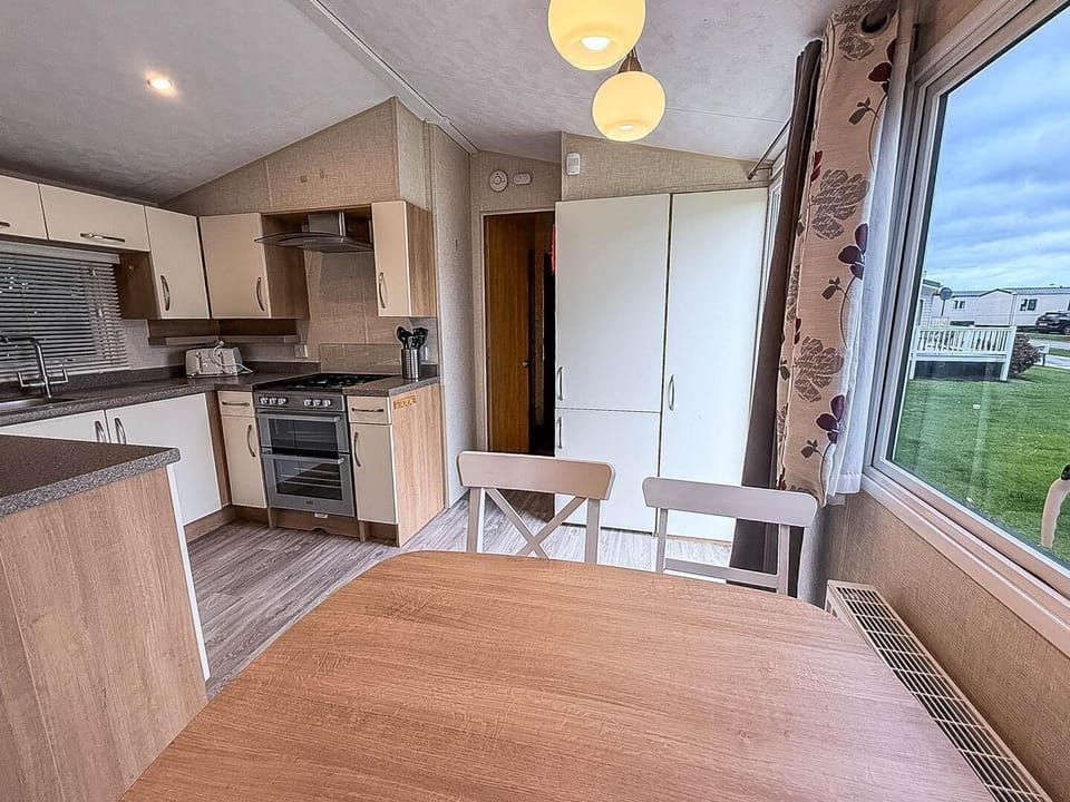 Kitchen complete with a spacious dining table—perfect for gathering after a day at Scratby Beach,