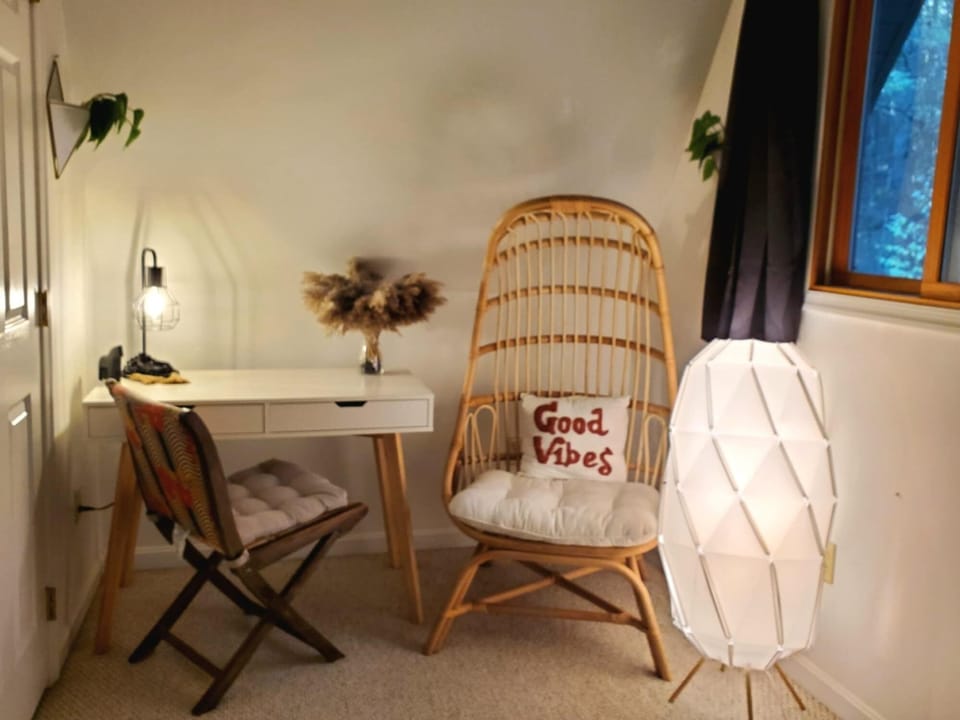 Other half of the secondary bedroom with work space and lounge space.