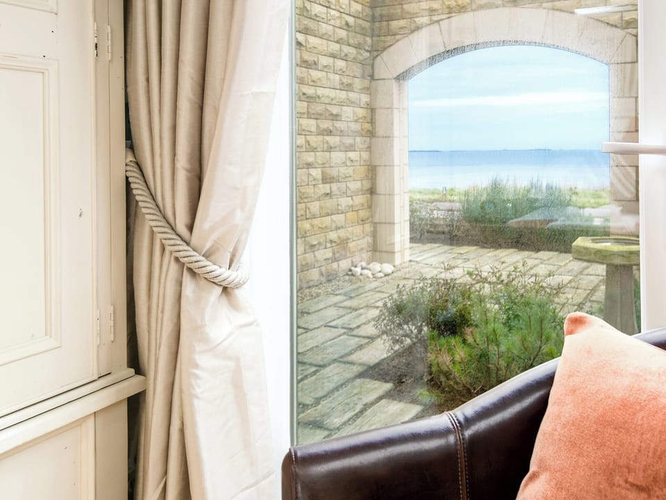 Seating in the bedroom allows for the ever-changing views to be studied for hours on end | Spindrift, Seahouses