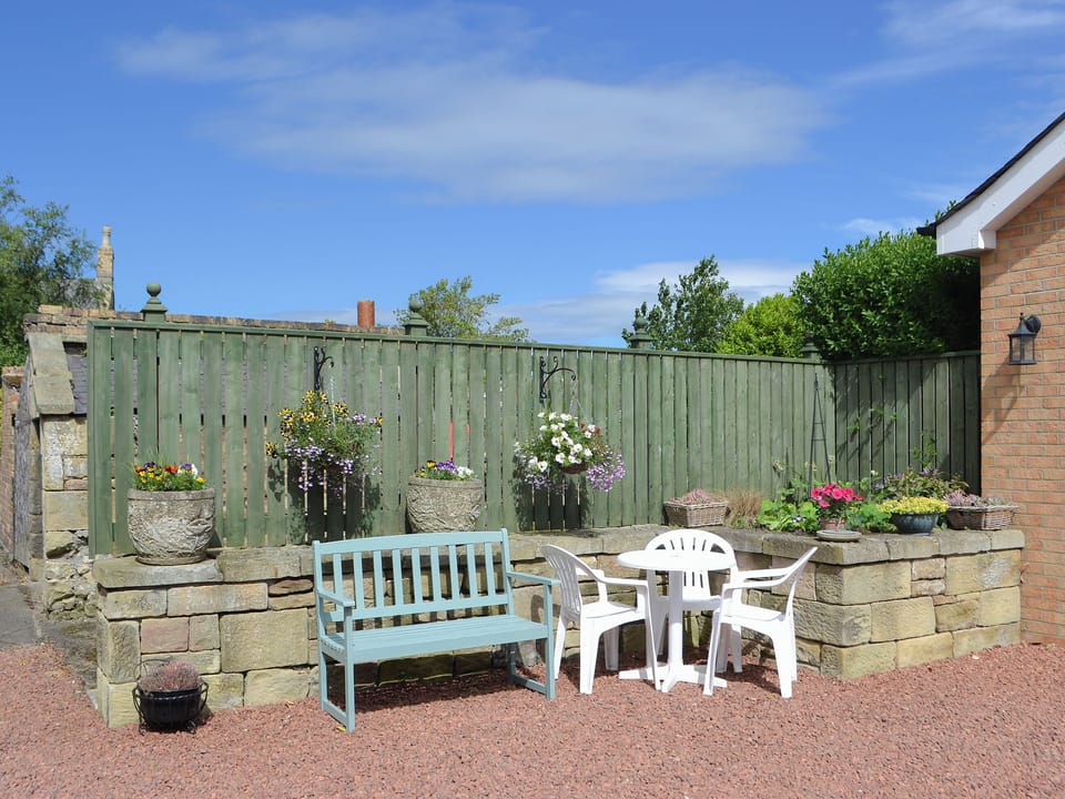 Gravelled patio with outdoor furniture at rear | Barkers Cottage, Ellington, near Druridge