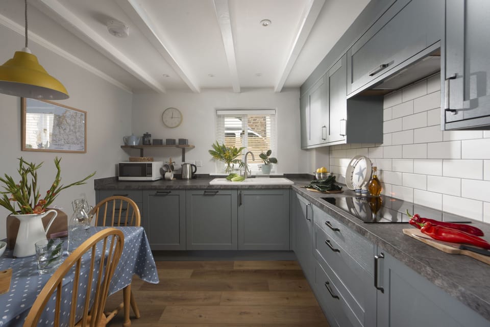 Bowjy Cottage, St Agnes. Ground Floor: Including an electric oven, induction hob, microwave, fridge/freezer and dishwasher