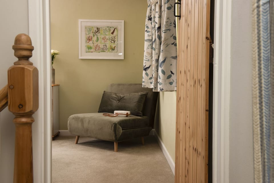 Bowjy Cottage, St Agnes. Second Floor: This lovely chair converts into a single bed