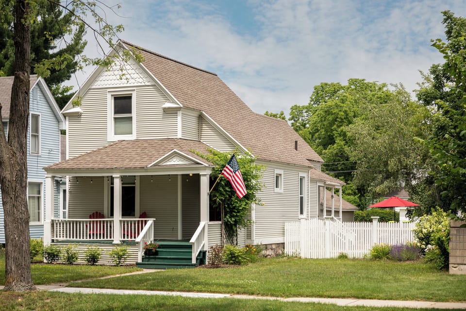 Discover this picturesque two-story home in a tranquil suburban neighborhood. Unwind on the cozy front porch while the American flag waves proudly. Ideal for families seeking comfort and serenity. 🏡🇺🇸