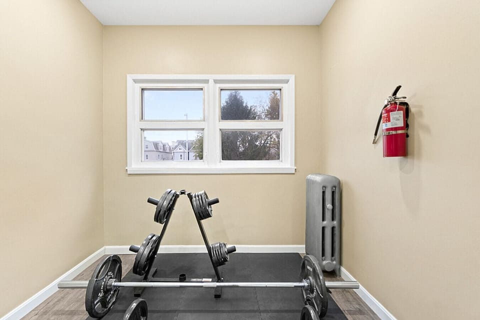 Fully equipped workout space with weights, providing a great spot for strength training and exercise.