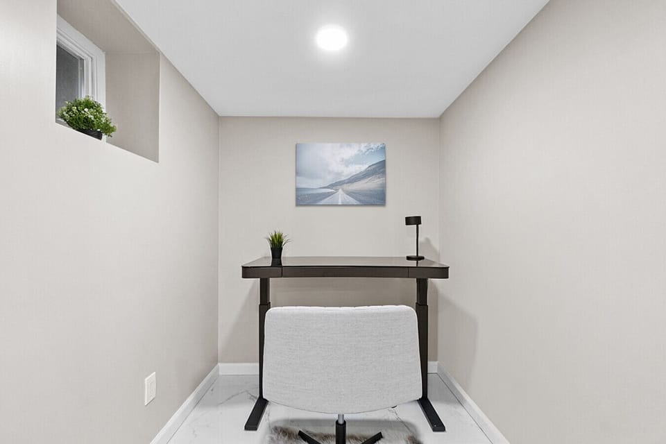 Dedicated home office setup with a sleek desk and cozy chair—perfect for productive work or study sessions.
