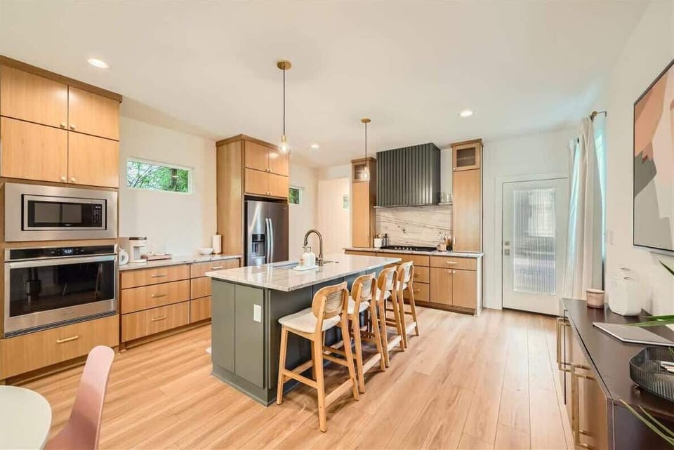 Warm and inviting kitchen with beautiful countertops and all the comforts of home.