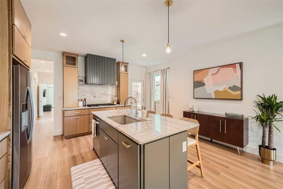Experience the fully stocked kitchen, equipped with modern appliances and all the essentials for cooking and entertaining. The spacious island offers additional seating, making it the perfect spot for meals or socializing.