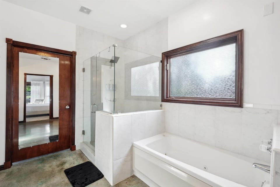 Clean bathroom with tub and shower combination.