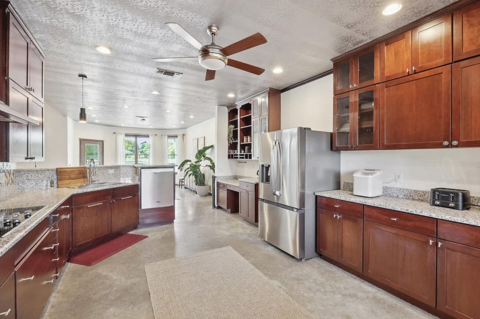 Spacious kitchen with sleek cabinetry and open layout.