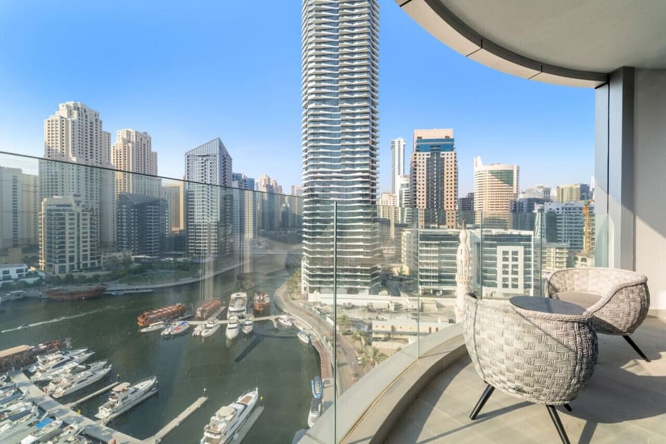 Balcony Oasis: Unwind with stunning city views and modern seating in this vibrant Dubai retreat!