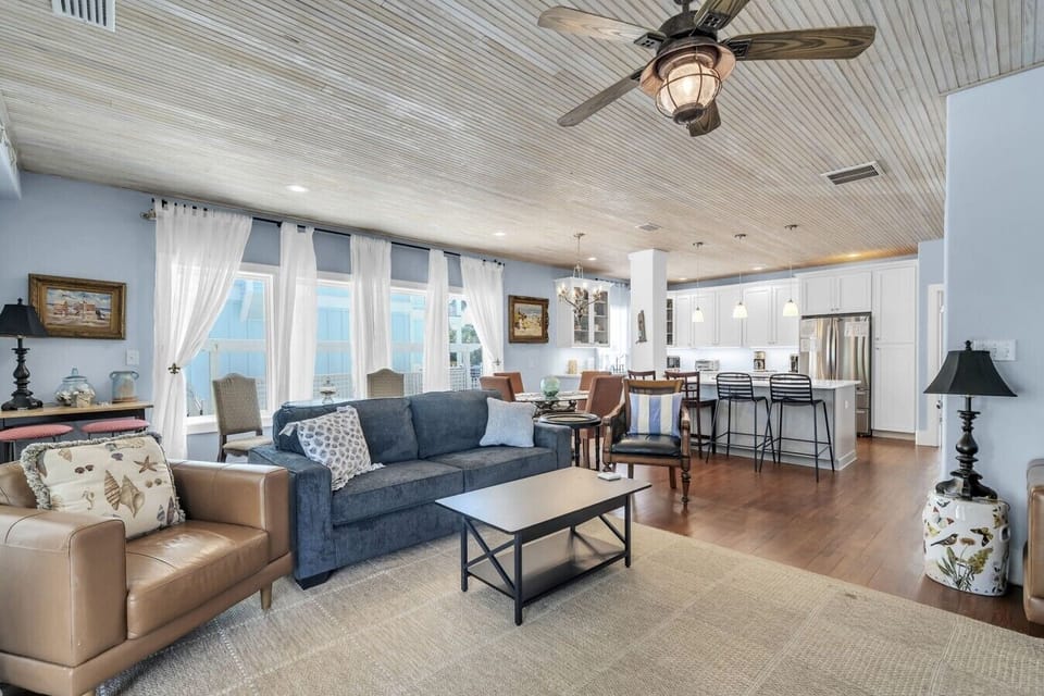 Family room with large tv and plenty of seating.