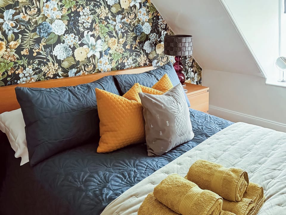 Beautifully decorated double bedroom with kingsize bed and single bed | 2 Northbank Cottages, Whiting Bay, Isle of Arran