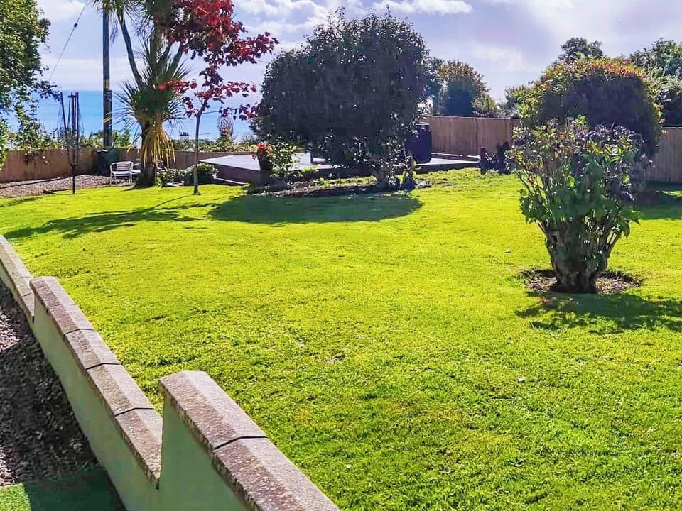 Secure Large Garden with uninterrupted sea views with multiple seating areas to relax and unwind | 2 Northbank Cottages, Whiting Bay, Isle of Arran
