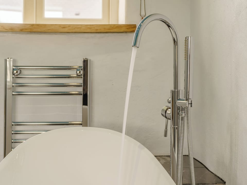 Heated towel rail within the bathroom | The Cowshed - Musselwick Farm, St Brides