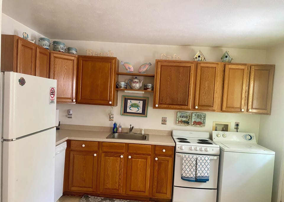 Kitchen with frig/freezer, stove, dishwasher, microwave, coffee bar, toaster.