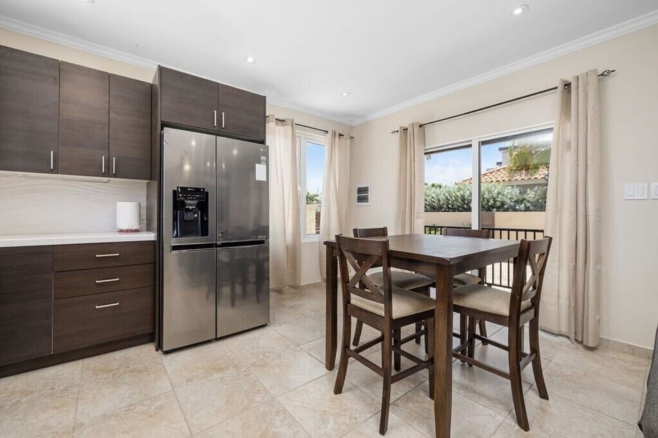 Fully equipped kitchen with modern appliances including a microwave, refrigerator, stove, oven, coffee maker, dishwasher, and all the dishes and utensils needed for easy meal prep.