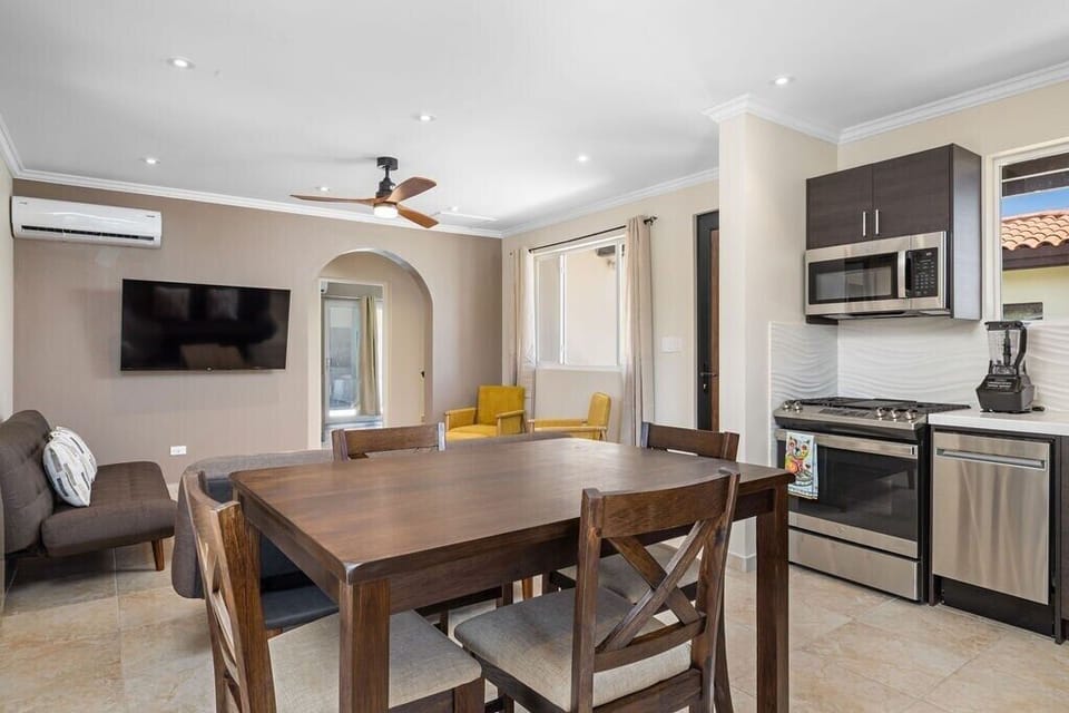 Adjacent to the fully equipped kitchen, the dining area offers a comfortable space for meals and gatherings. Enjoy family dinners or casual meals in this welcoming and spacious area.