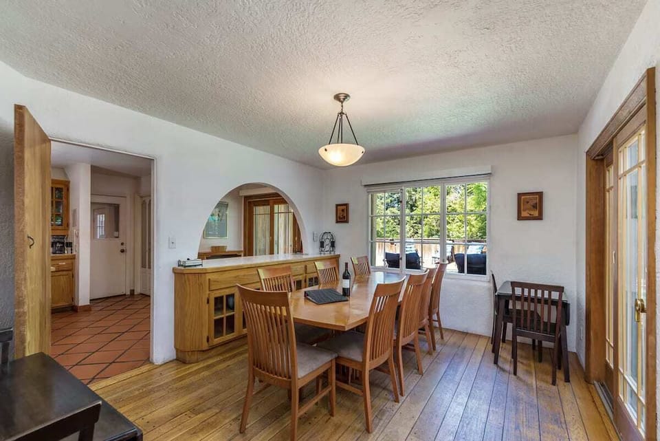 The dining room overlooking the pool with redwood views.