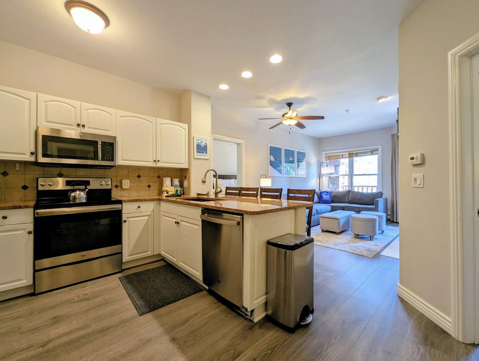 A bright, open kitchen flows into a cozy living room, where you'll love cooking and relaxing. Granite counters, stainless appliances, and everything you need for a comfortable stay.