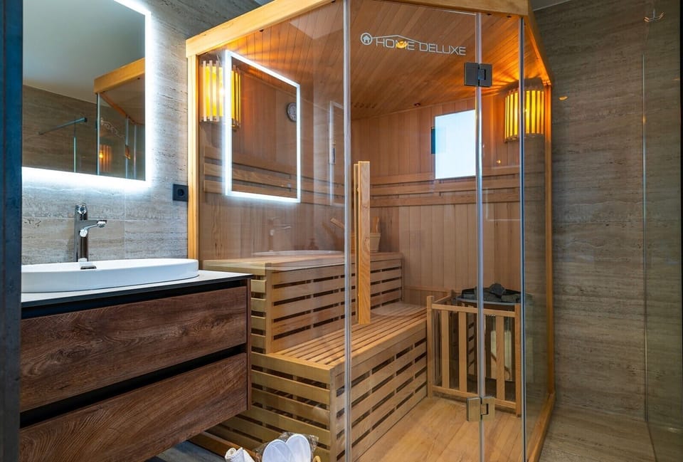 En suite bathroom with a Finnish sauna and a shower