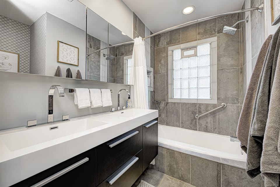 The main-floor bathroom offers two sinks and a shower and tub combination.