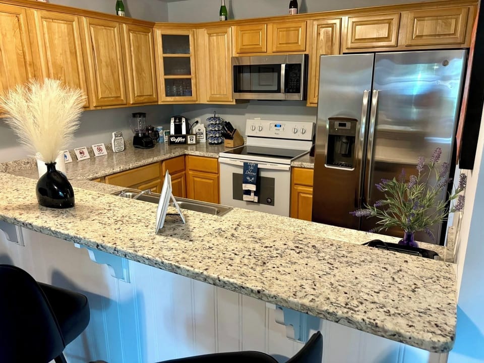 Kitchen: Stylish design with gleaming granite counters and modern appliances for culinary adventures!