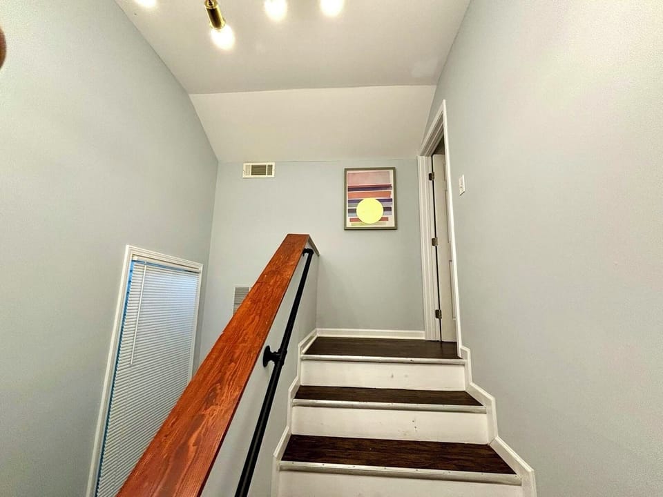 Staircase: Radiant lighting guides you to elegant spaces adorned with modern art.