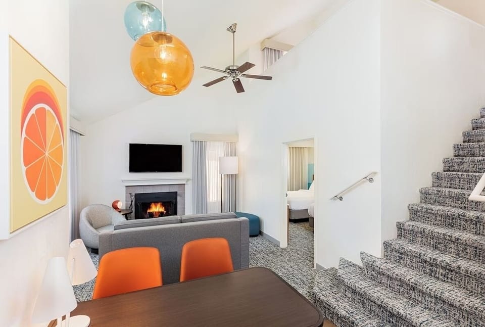 Gather by the glowing fireplace in this airy, loft-style suite.