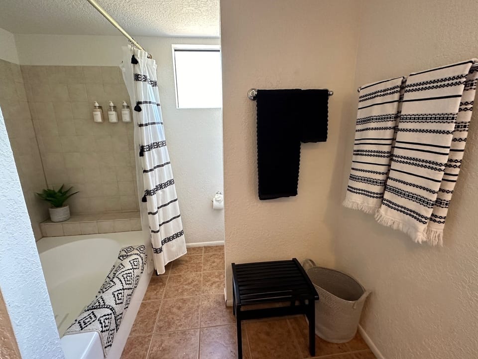 Large garden tub with full shower and restroom
tucked behind the wall 