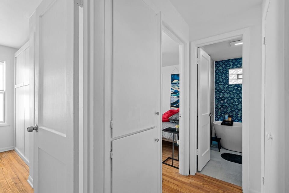 Bright and modern hallway leading to stylish bedrooms.