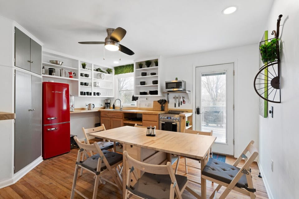 Retro Charm Meets Modern Convenience – A fully stocked kitchen with a bold red fridge.