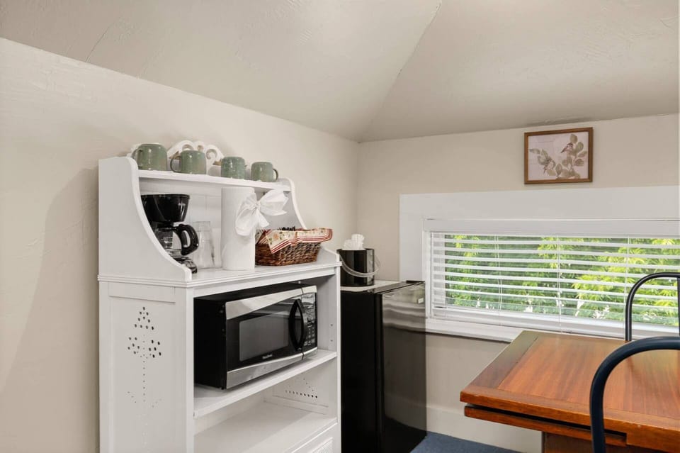 Wake up and enjoy coffee from the kitchenette area, featuring a mini fridge, microwave, and coffee maker.
