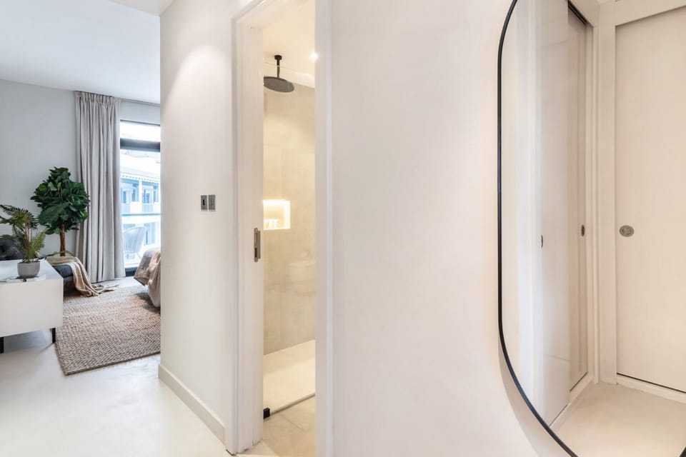 Beautiful Master bedroom with king sized bed, walk through wardrobe area, large ensuite, large Samsung Smart TV and balcony with seating