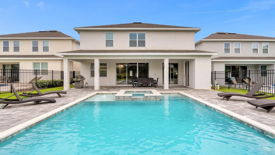 Relax in your private oasis with a sparkling pool, hot tub, and outdoor dining area—perfect for family gatherings and sun-soaked afternoons.