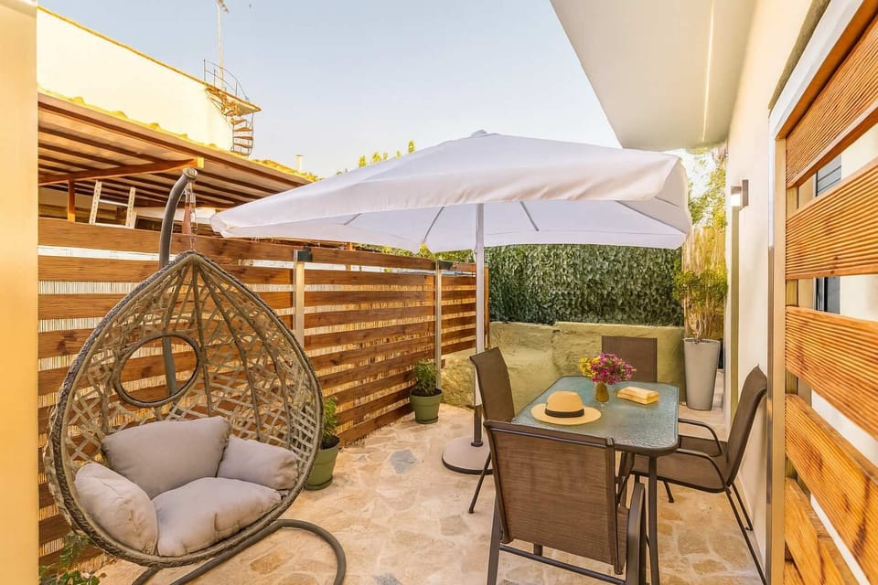 Outdoor Dining Area with Shade and Hanging Chair – Perfect for Relaxation
