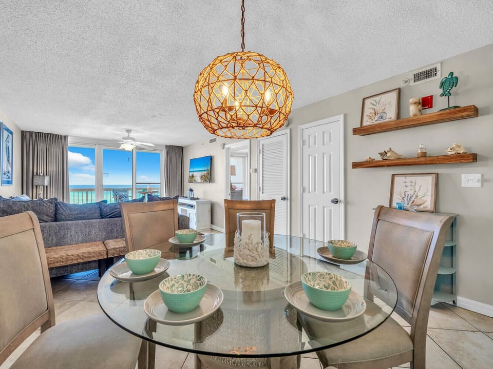 Your elegant dining space features a glass table set for memorable meals, while the stunning ocean view creates the perfect coastal dining atmosphere.