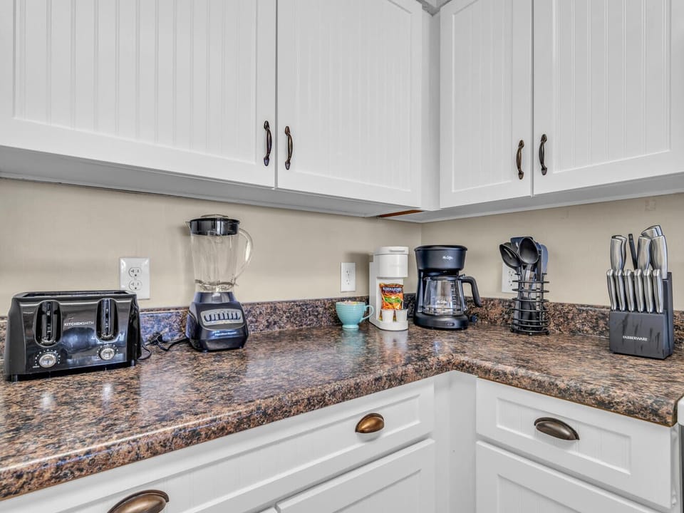 Your fully equipped kitchen features granite countertops and modern appliances, including a coffee maker for your morning routine.