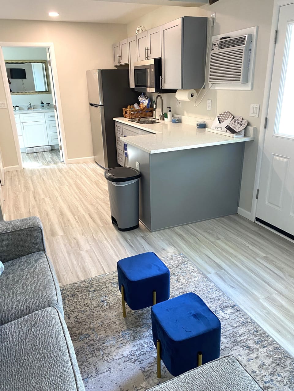 Main living area include a cozy couch and clean countertops.