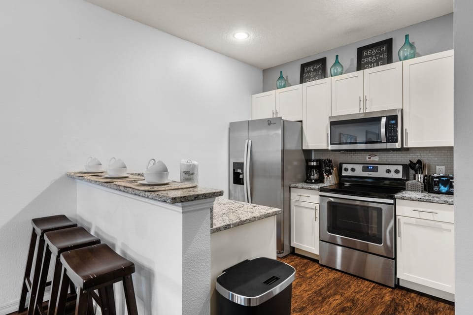 Well-equipped kitchen with bar stools.
